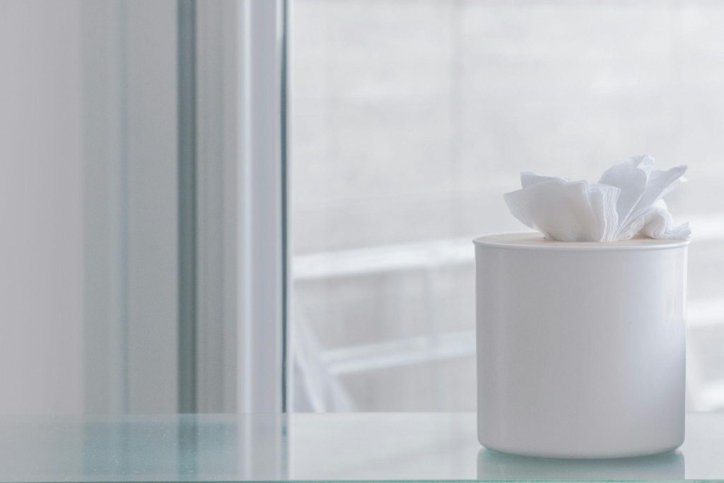 Image of a white paper towel dispenser on top of a table