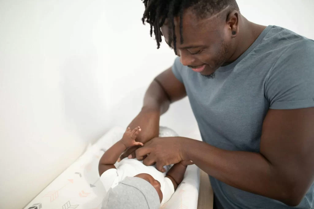 Man with a baby in a toilet with no proper baby changing station